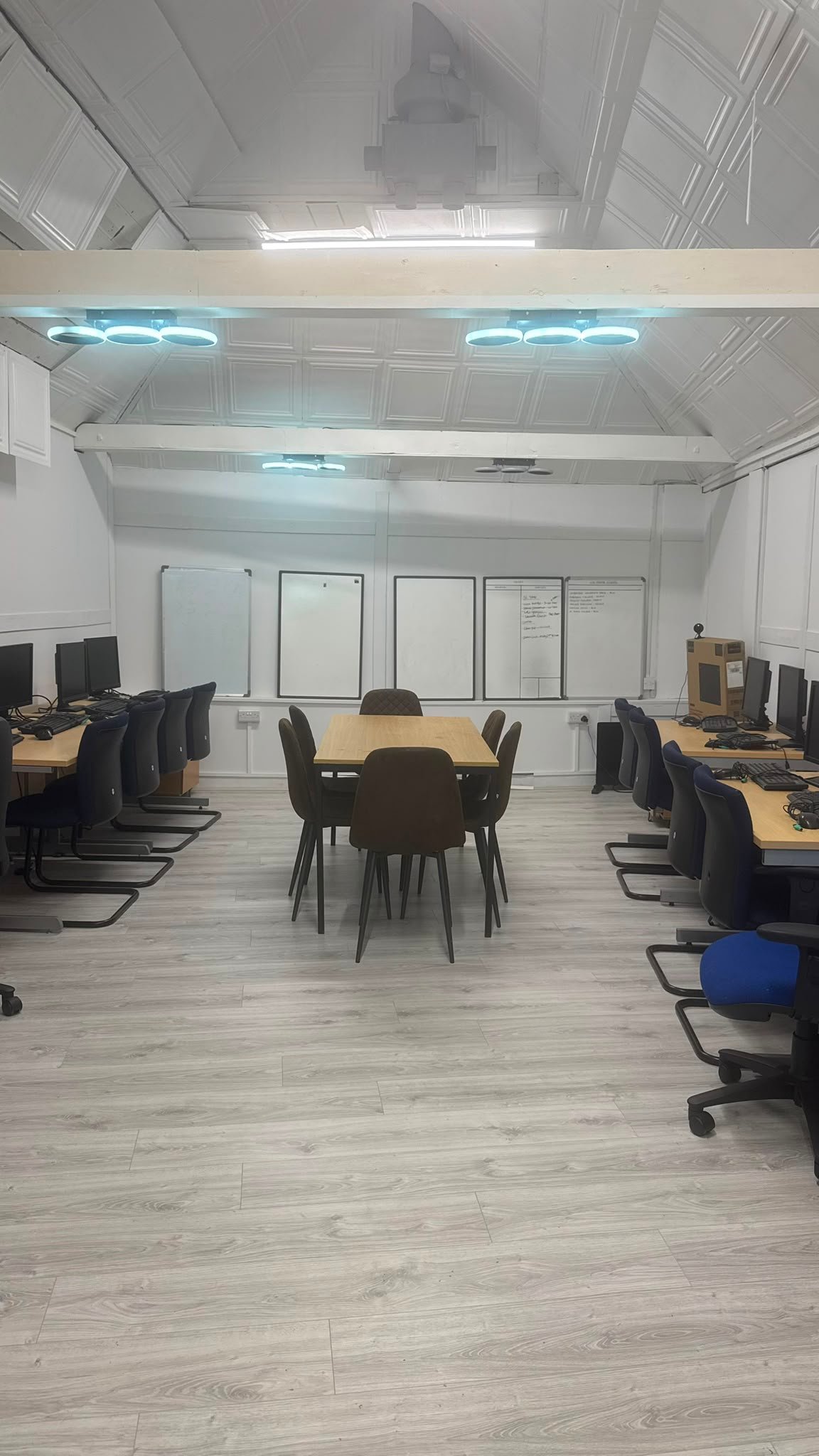 Our Space at 13 Weeks Café — computers, meeting table and presentation boards